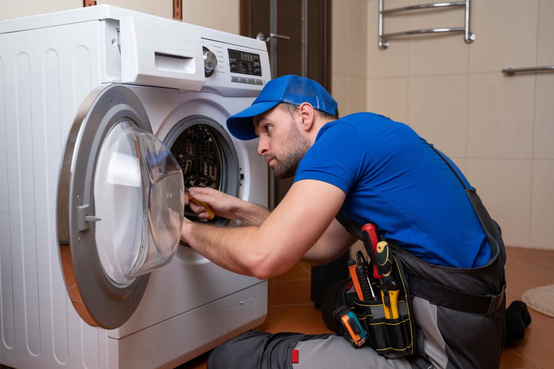 Appliance Pro Care Technician Repairing a Washing Machine